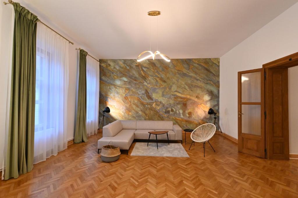 a living room with a couch and a painting on the wall at Althof Apartments in Sibiu