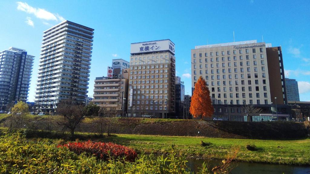 a group of tall buildings in a city at Toyoko Inn Morioka eki Minami guchi Ekimae in Morioka