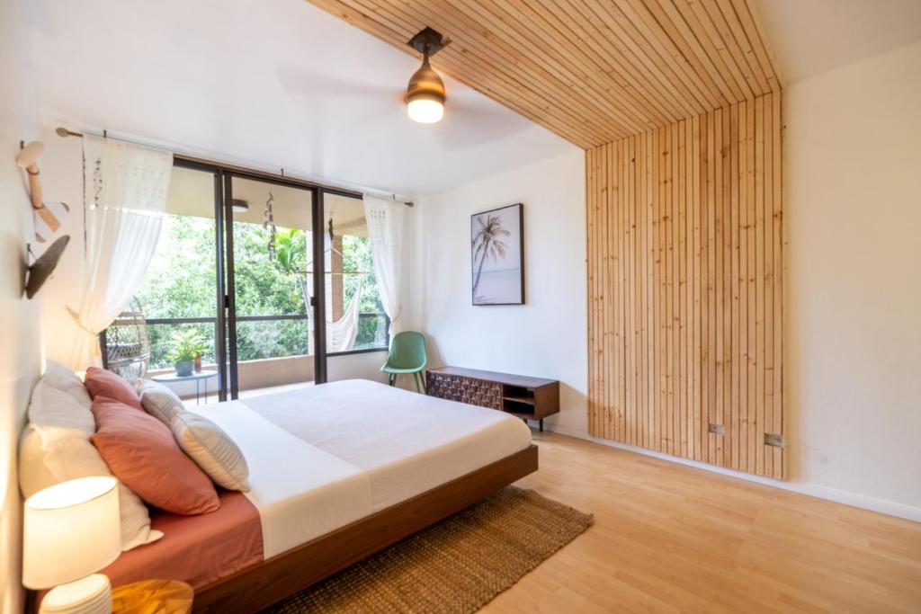 - une chambre avec un lit et une grande fenêtre dans l'établissement Sohana Lifestyle Apartment I Leeven's Home I Kona, à Kailua-Kona