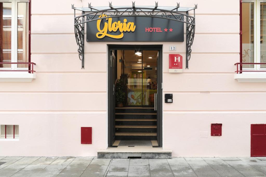 a building with a sign that reads victory hotel at Hôtel Gloria in Grenoble