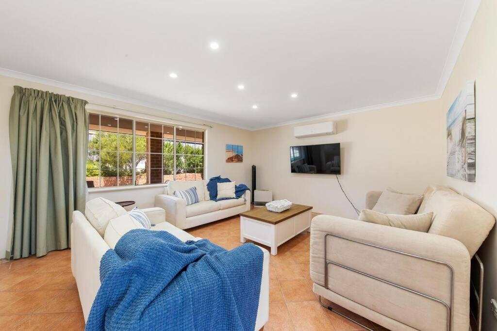 a living room with two couches and a tv at Light & bright Falcon Bay family holiday escape in Mandurah