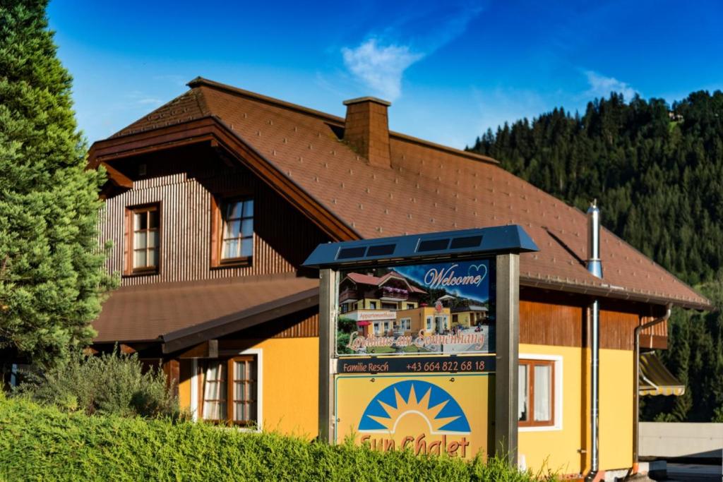 a house with a sign in front of it at Sun Chalet in Schladming