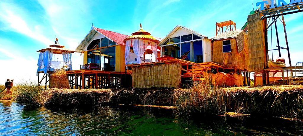 une maison assise au-dessus d'une masse d'eau dans l'établissement Uros Lake Titicaca Lodge, à Puno