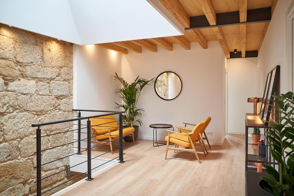 a dining room with yellow chairs and a table at Brito Capelo 183 in Matosinhos