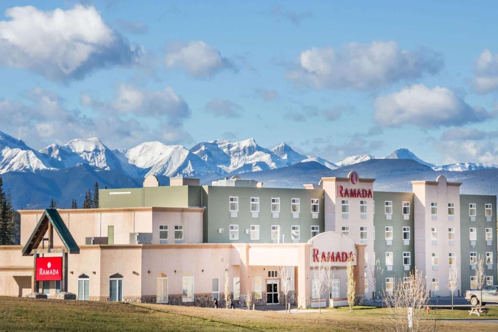 ein Hotel mit schneebedeckten Bergen im Hintergrund in der Unterkunft Ramada by Wyndham Hinton in Hinton