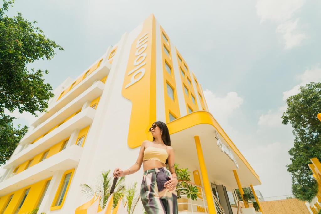 a woman standing in front of a building at Bloom Hotel - Sector 62 in Noida