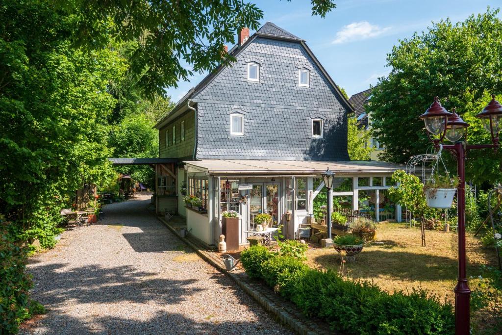 a house with a garden in front of it at Land & Leben Pension in Chemnitz