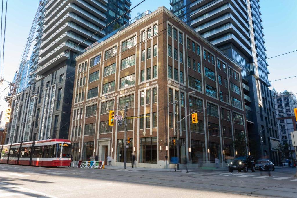 un gran edificio en una calle de la ciudad con un autobús en Sutton Place Hotel Toronto, en Toronto