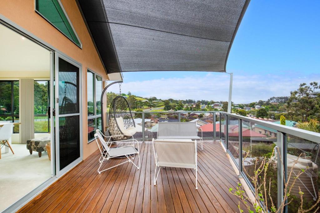 a patio with a table and chairs on a deck at Villa Franco Pet Friendly 10 Mins Walk to Beach in Surf Beach