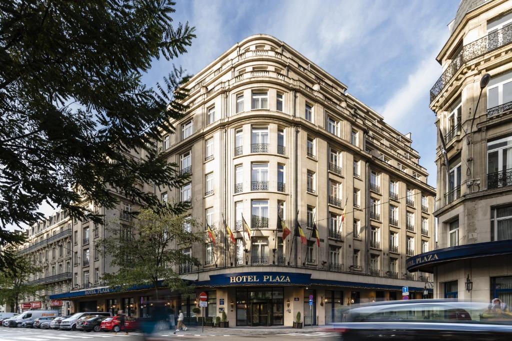 a building on a street with cars in front of it at Hotel Le Plaza Brussels in Brussels