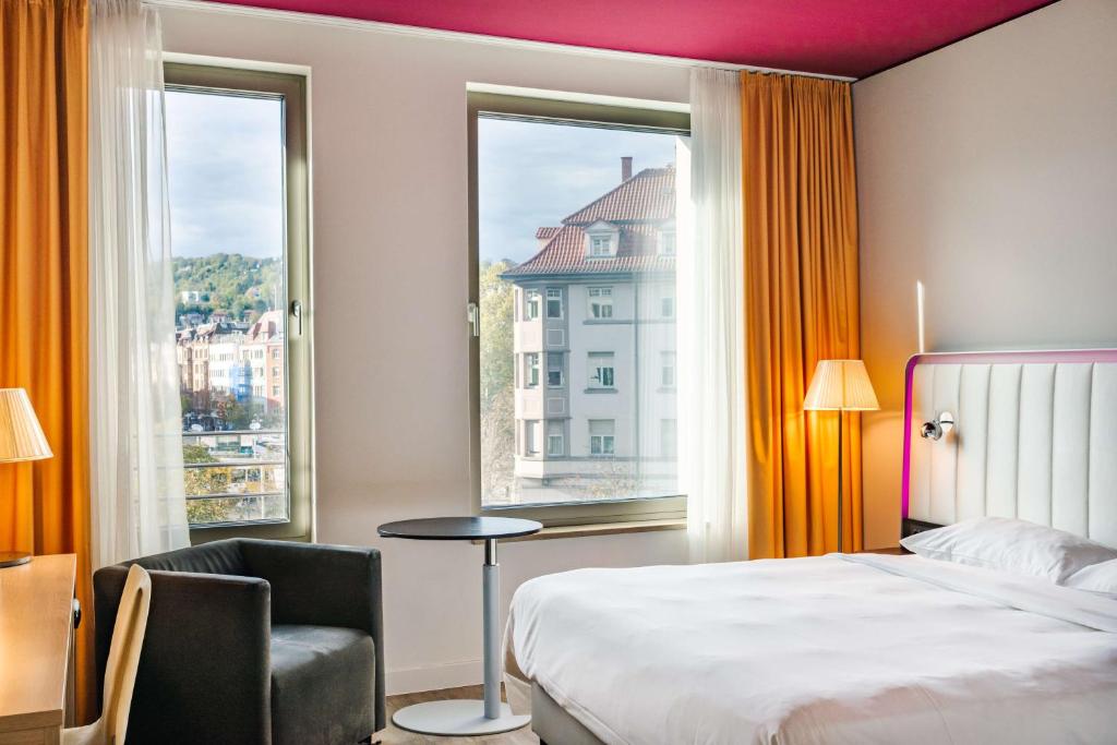 A bed or beds in a room at Park Inn by Radisson Stuttgart