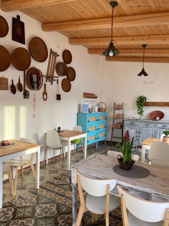 a dining room with tables and chairs and wooden ceilings at Torremana in Càbras