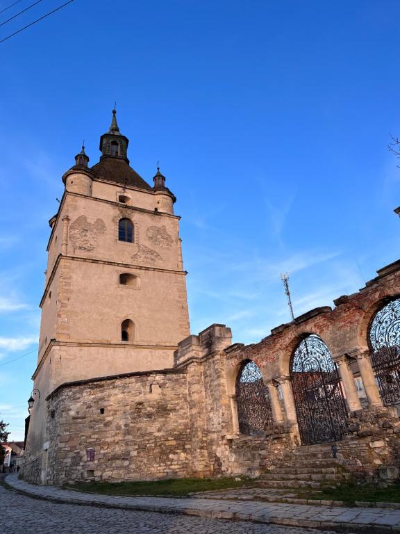 an old building with a tower on the side of it at Luxury Live in Kamianets-Podilskyi