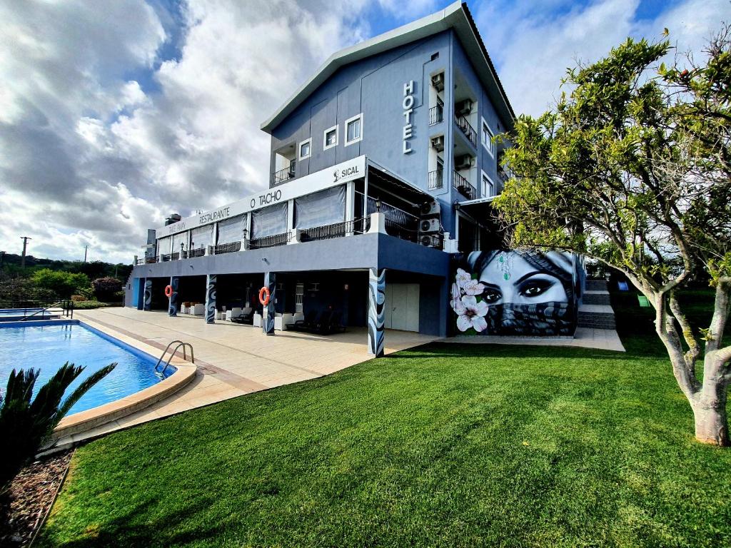 a building with a mural on the side of it at Hotel Don Rodrigues in Tavira