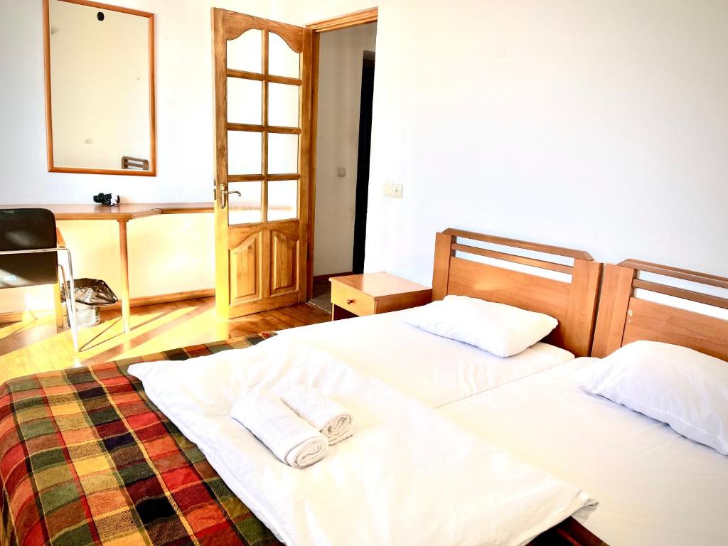 a bedroom with two beds with towels on them at YETI-clubcom in Gudauri