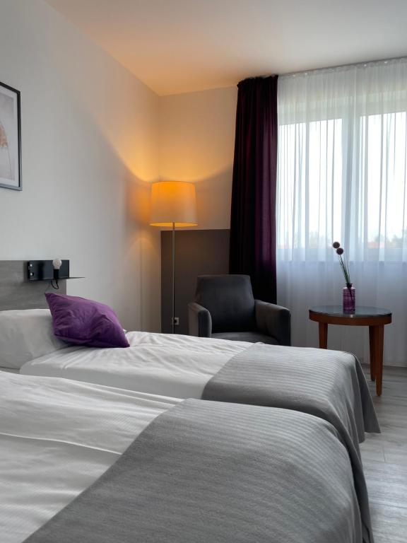 เตียงในห้องที่ PRIMA Inn HOTEL & HOF NEURUPPIN - digitales & rezeptionsloses Motel