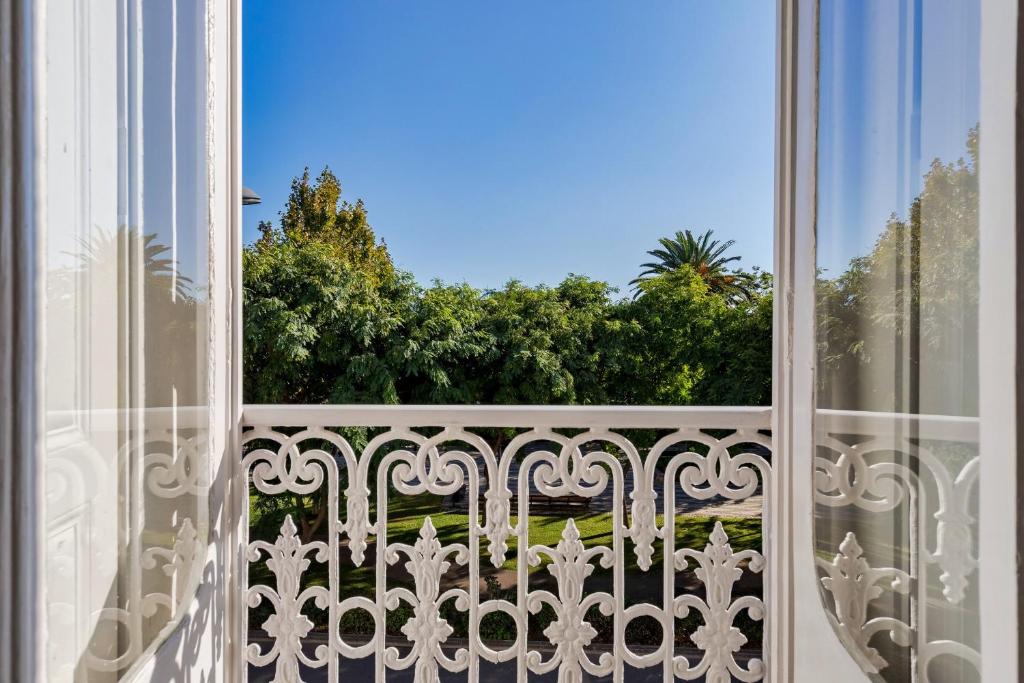 an open window with a view of a garden at Setubal Prime in Setúbal