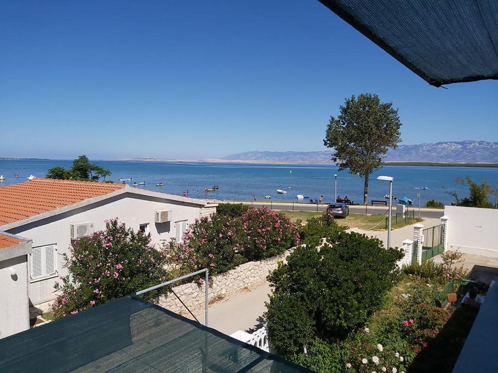 a view of the beach from a balcony of a house at Apartments Elvir Nin in Nin