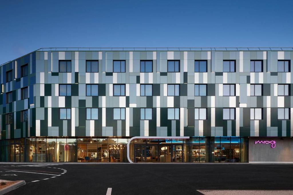 a building with a lot of windows on a street at Moxy Sophia Antipolis in Biot