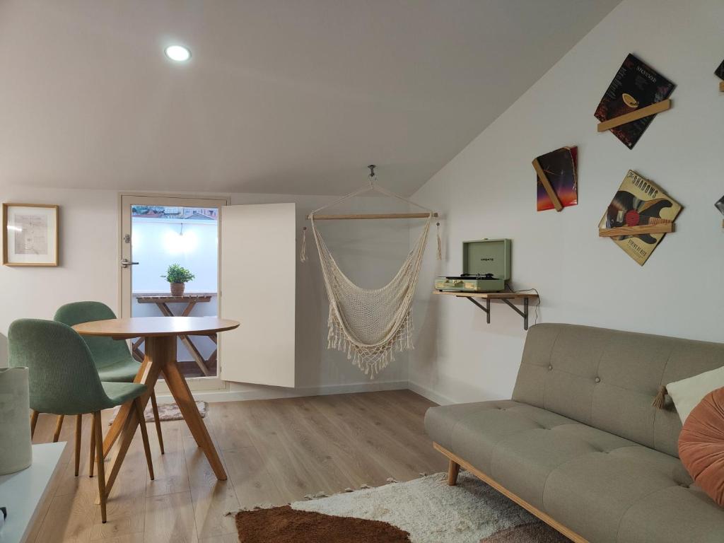 un soggiorno con divano e tavolo di Wood Essence Apartment - Cozy Balcony a Coimbra