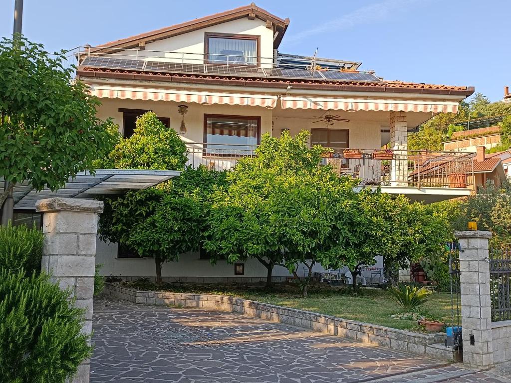 a house with a walkway in front of it at Apartmaji Ri-100 in Portorož