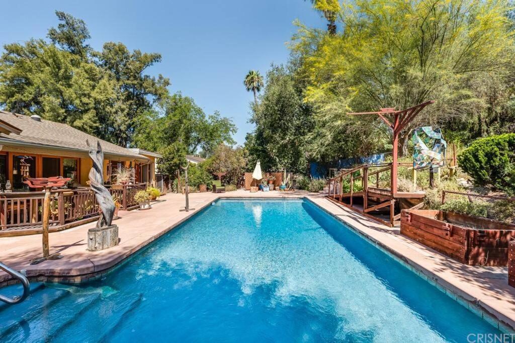 a swimming pool in a yard with a house at Villa La Reforma - Newly Designed 4BR HOUSE & POOL in Los Angeles by Topanga in Los Angeles