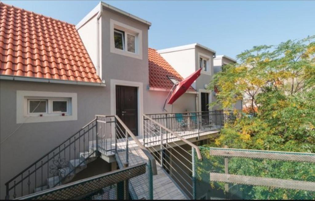 a house with a staircase leading to a balcony at Bika in Omiš