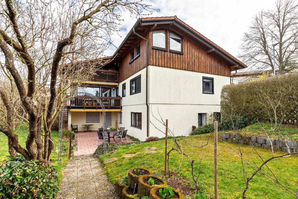 a large white house with a wooden roof at Wächtersberg in Wildberg