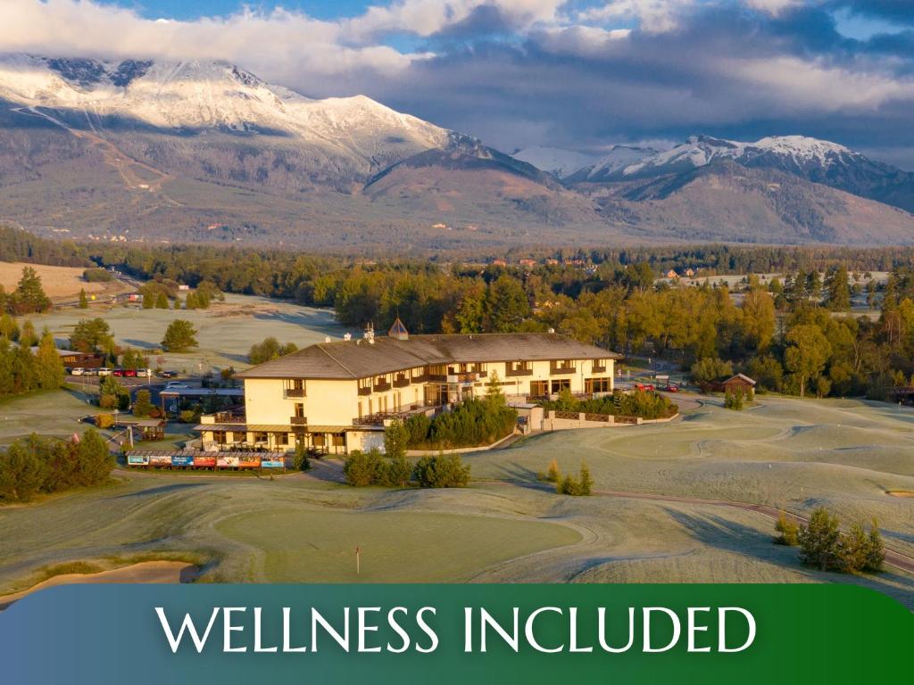 a view of a golf course with mountains in the background at Hotel International in Veľká Lomnica