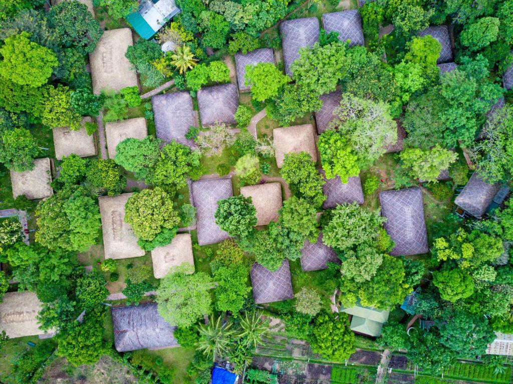 een uitzicht over een park met bomen en struiken bij Spice Village Thekkady - a CGH Earth Experience in Thekkady