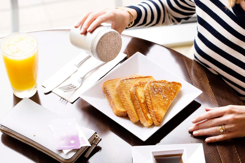 a table with a plate of toast and a drink at Hyatt Place Dallas/North Arlington/Grand Prairie in Arlington