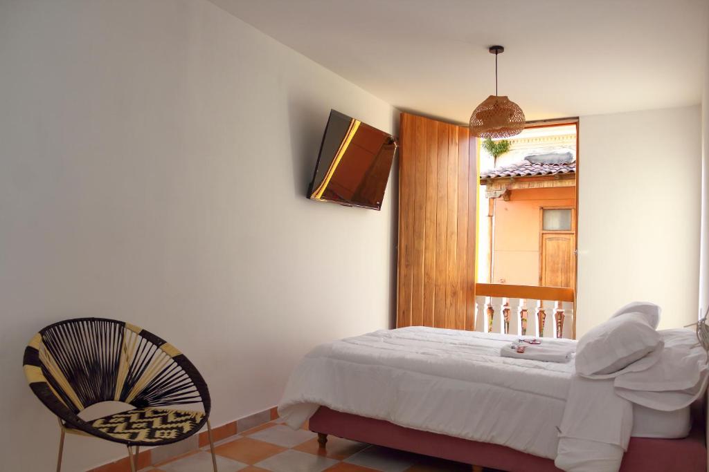 A bed or beds in a room at Hostal Casa Torres Centro Historico - Adults Only