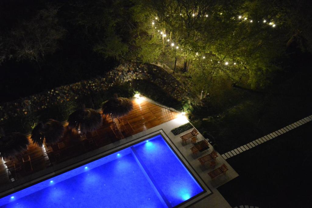 una vista panoramica su una piscina di notte di Olivia's Hill Resort a Durrës