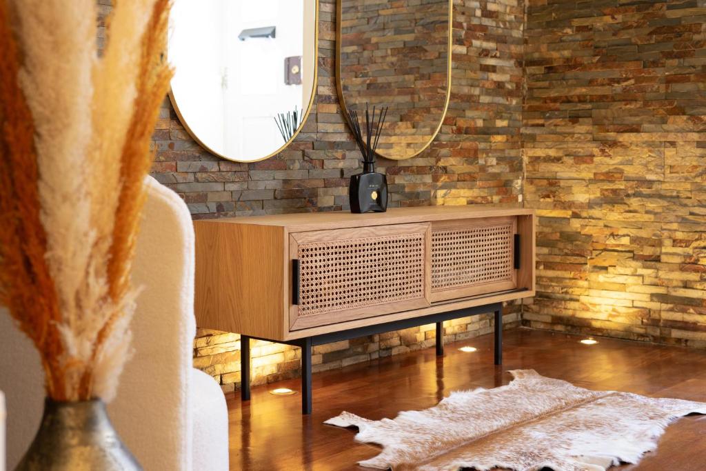 a living room with a tv and a mirror at Charming Apt in Historic House in Coimbra