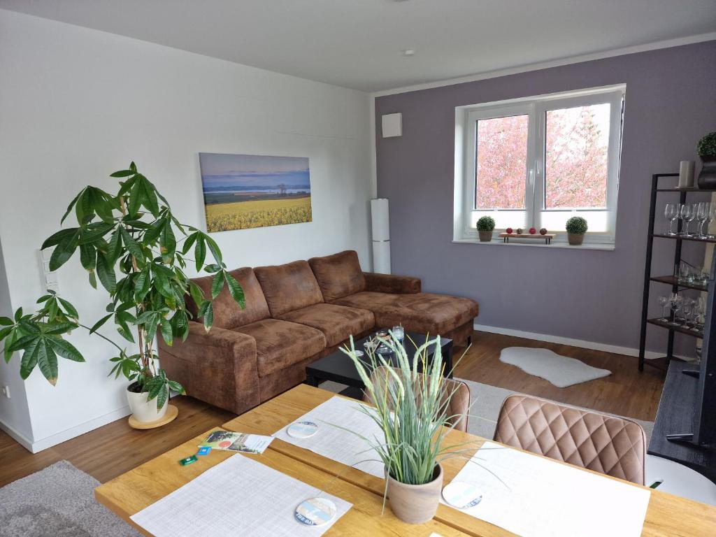 a living room with a couch and a table at Moderne Penthouse Wohnung in Schleswig