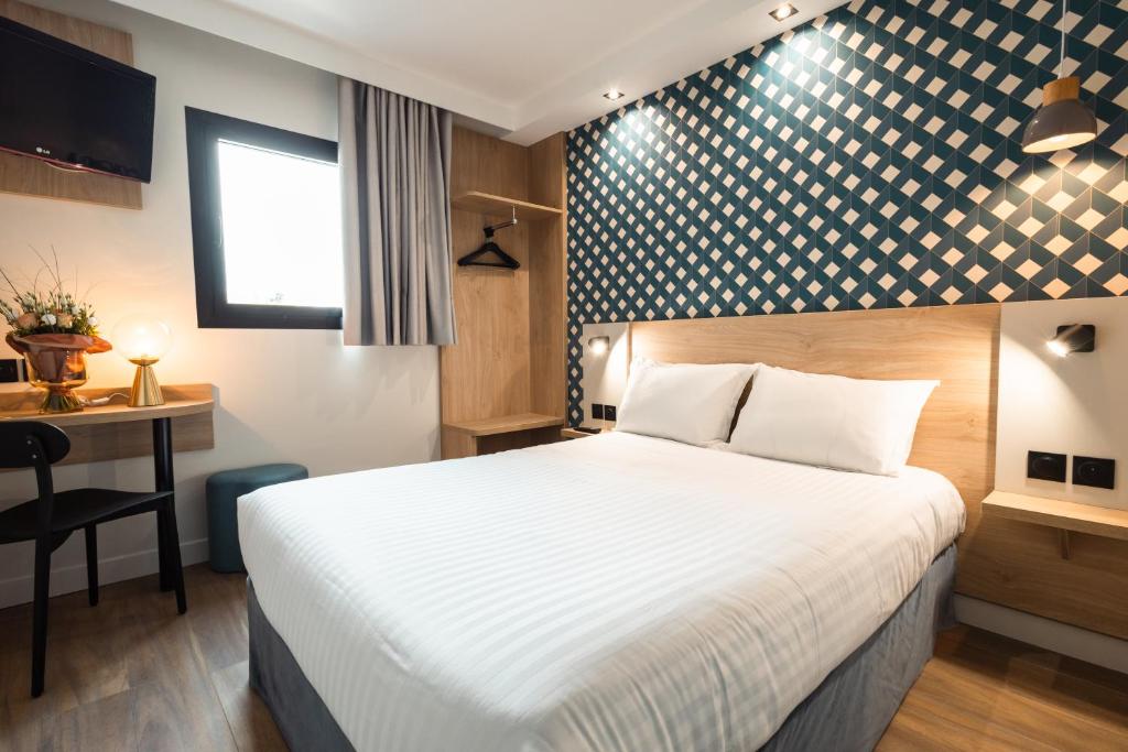 Cama ou camas em um quarto em KYRIAD DIRECT ORLEANS NORD - Cap Saran