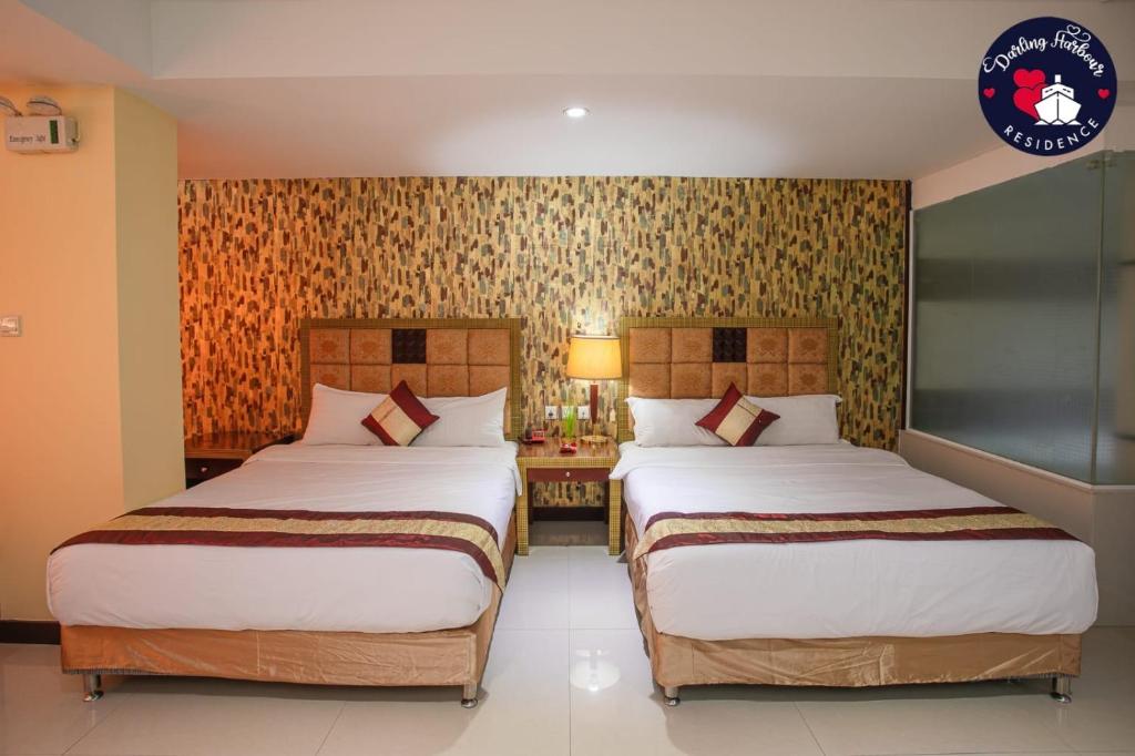 A bed or beds in a room at Darling Harbour Residence - South Pattaya