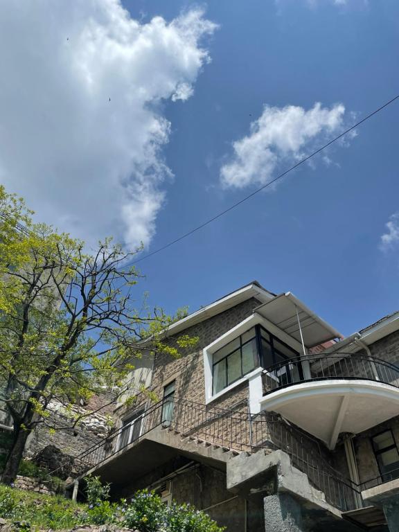 a house with a balcony on top of it at LOKAL Rooms x Murree Kashmir Point in Murree