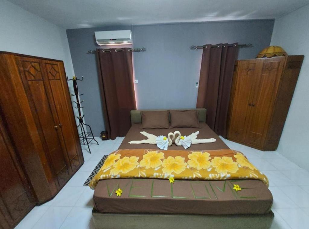 a bedroom with a bed with flowers on it at Justice Seaview Apartment in Le Morne