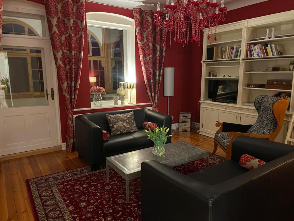 a living room with two couches and a table at Villa Klara Cieplice in Jelenia Góra