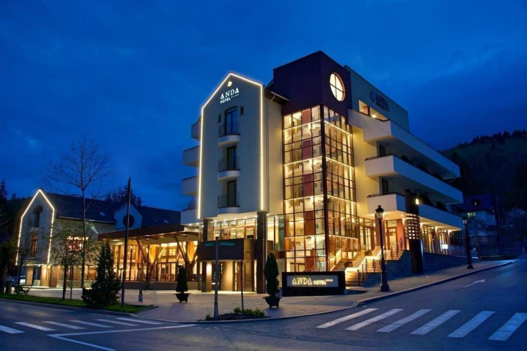 a building with a clock on the side of it at Hotel Anda in Sinaia