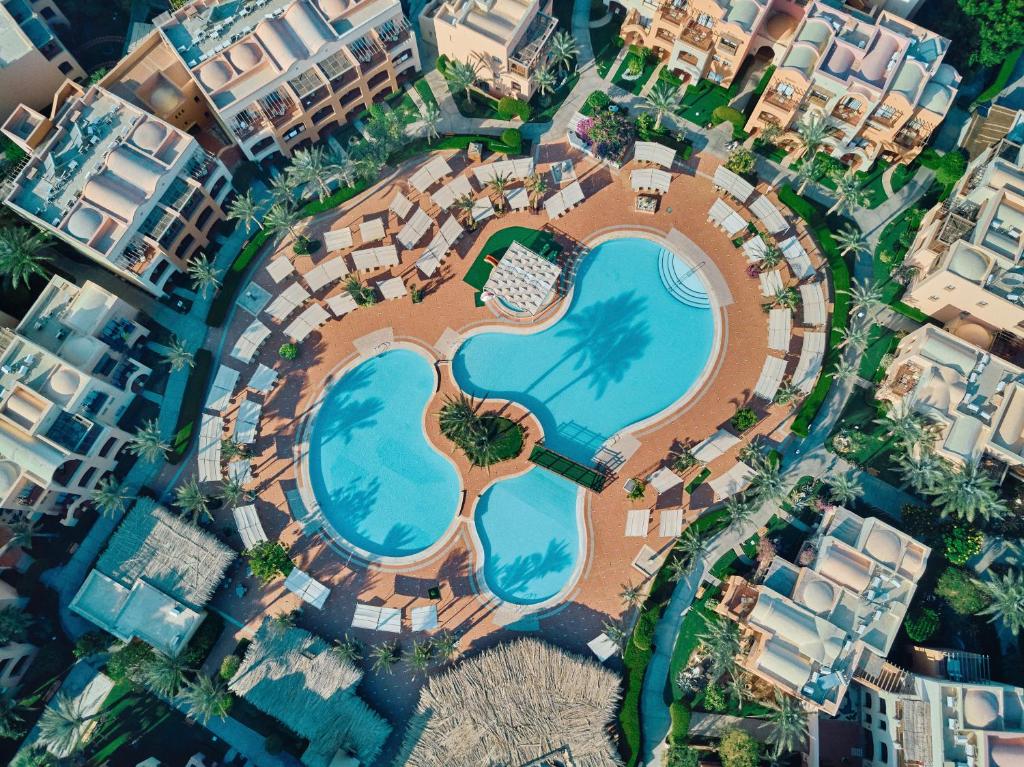 an aerial view of a resort with a swimming pool at Jaz Makadi Saraya Resort in Hurghada