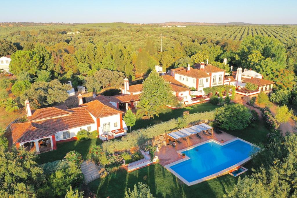 an aerial view of a house with a swimming pool at Hotel Rural Monte da Provença in Elvas