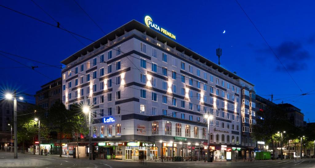 a building with a sign on top of it at night at PLAZA Premium Columbus Bremen in Bremen