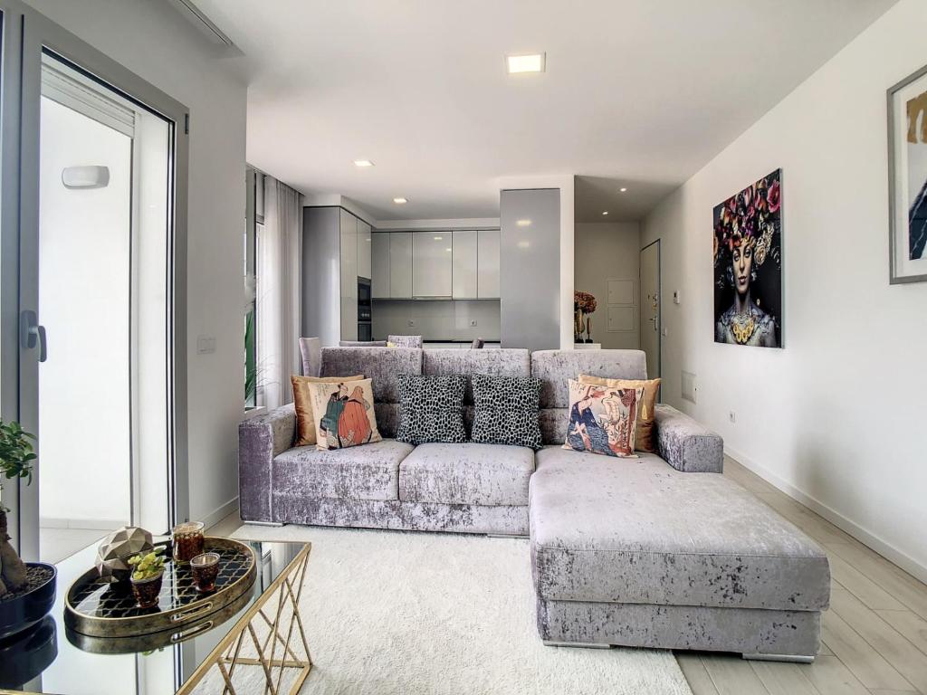 a living room with a couch and a table at Rancho Tá-Mar Apartment Nazaré Beach in Nazaré