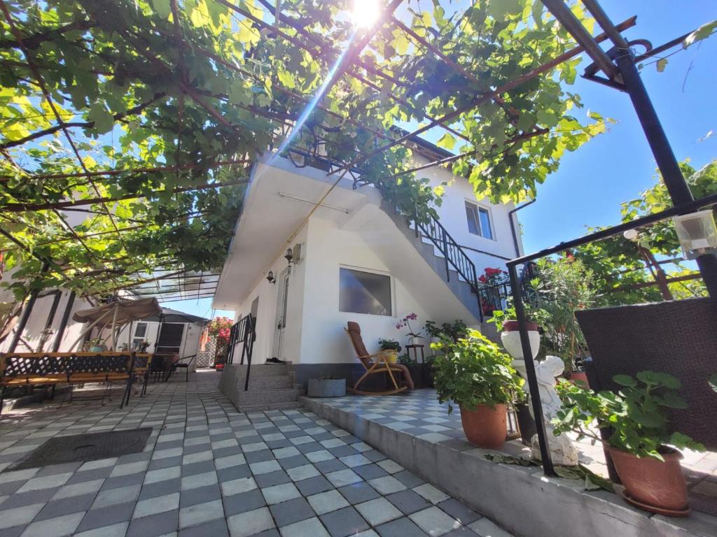 a small white house with trees in front of it at Vila Didi, Mangalia in Mangalia