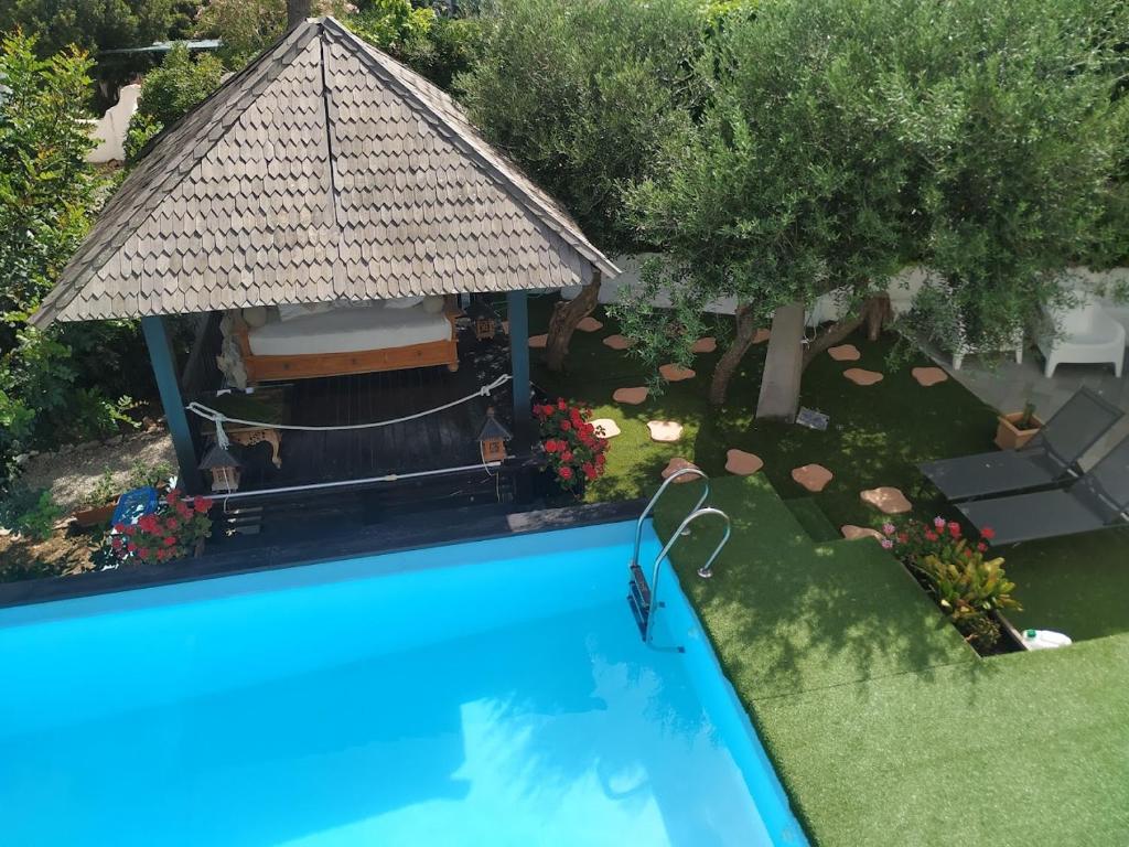 an overhead view of a swimming pool with a gazebo at GAETA - Villa Fontania in Gaeta