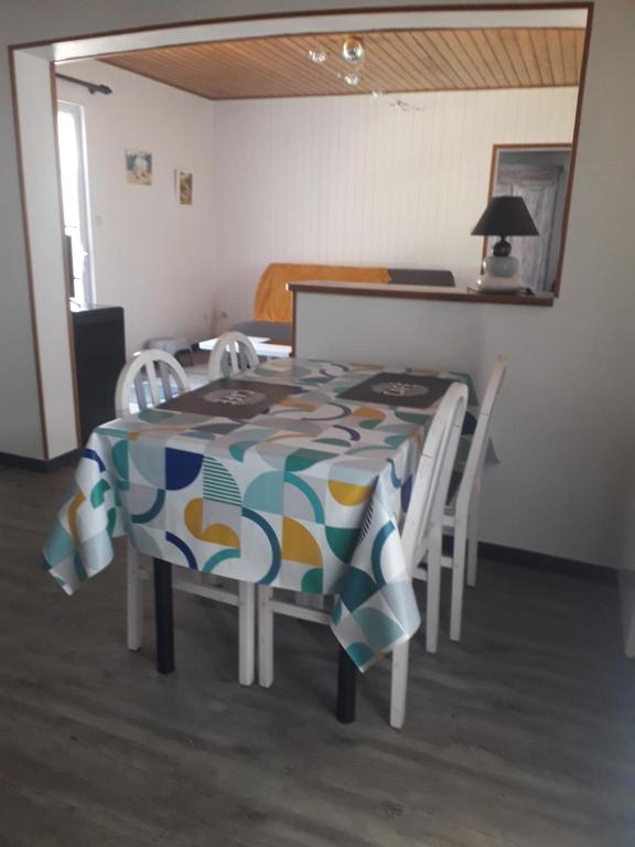 a dining room table and chairs with a colorful table cloth at MADALNY HOUSE in La Garnache