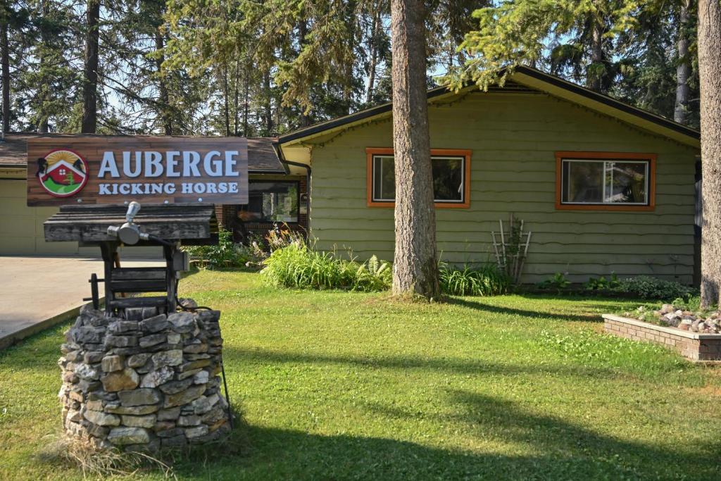 a sign for an entrance to a lodging house at Auberge Kicking Horse Guest House in Golden