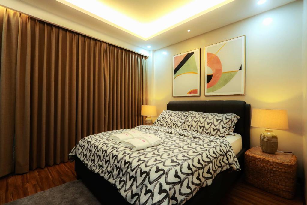 um quarto com uma cama e cortinas em preto e branco em Gloria Tree Mayon and Park View Residences em Legazpi